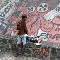Poor vendor in Salvador da Bahia prepares his merchandise