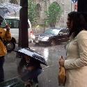 When the rain starts, an enterpreneur sells $5 umbrellas to pedestrians