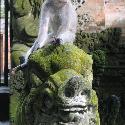 Monkey sitting on top of a temple sculpture